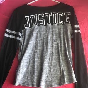 A black and gray long sleeve with the Justice logo